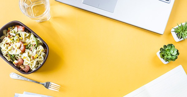 A lunch sitting on a yellow desk