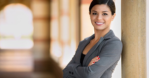 Woman in work clothes with arms crossed