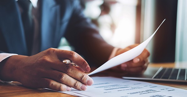 Up close image of man holding resume