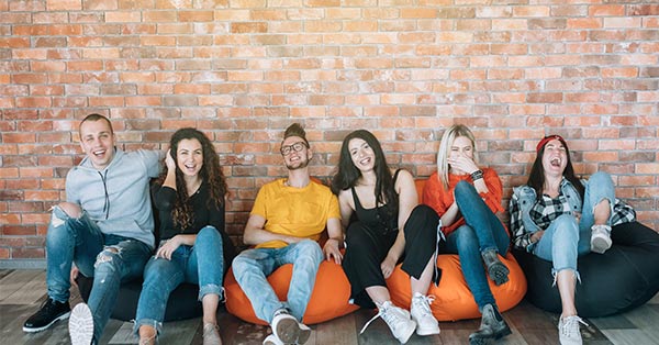 Group of employees laughing and sitting on bean bags