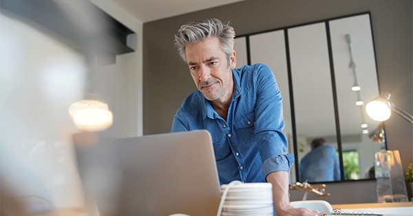 Man working on laptop from a home office